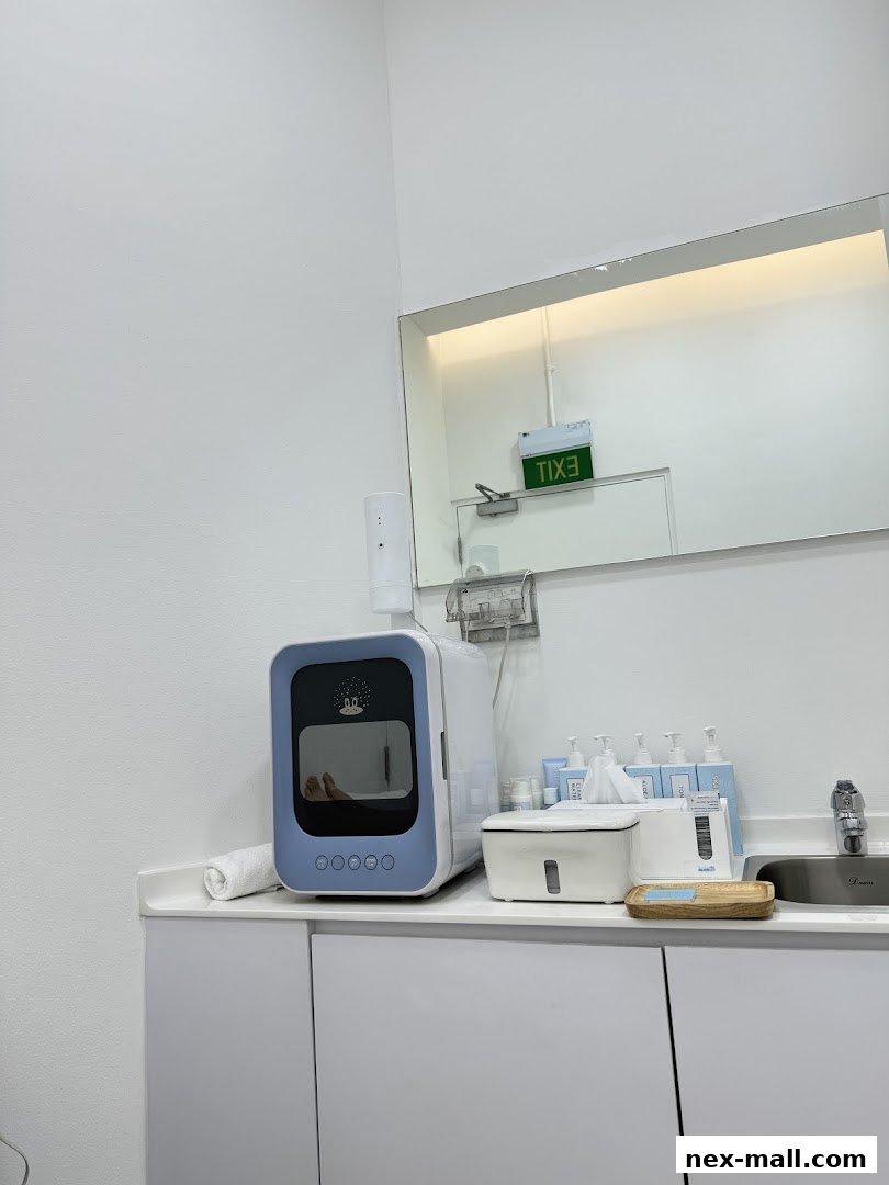 A clean counter with beauty equipment, products, and a sink.