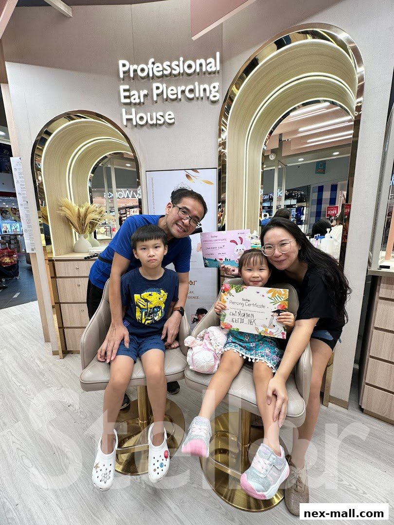A family poses with a piercing certificate at Stellar NEX Ear Piercing House.