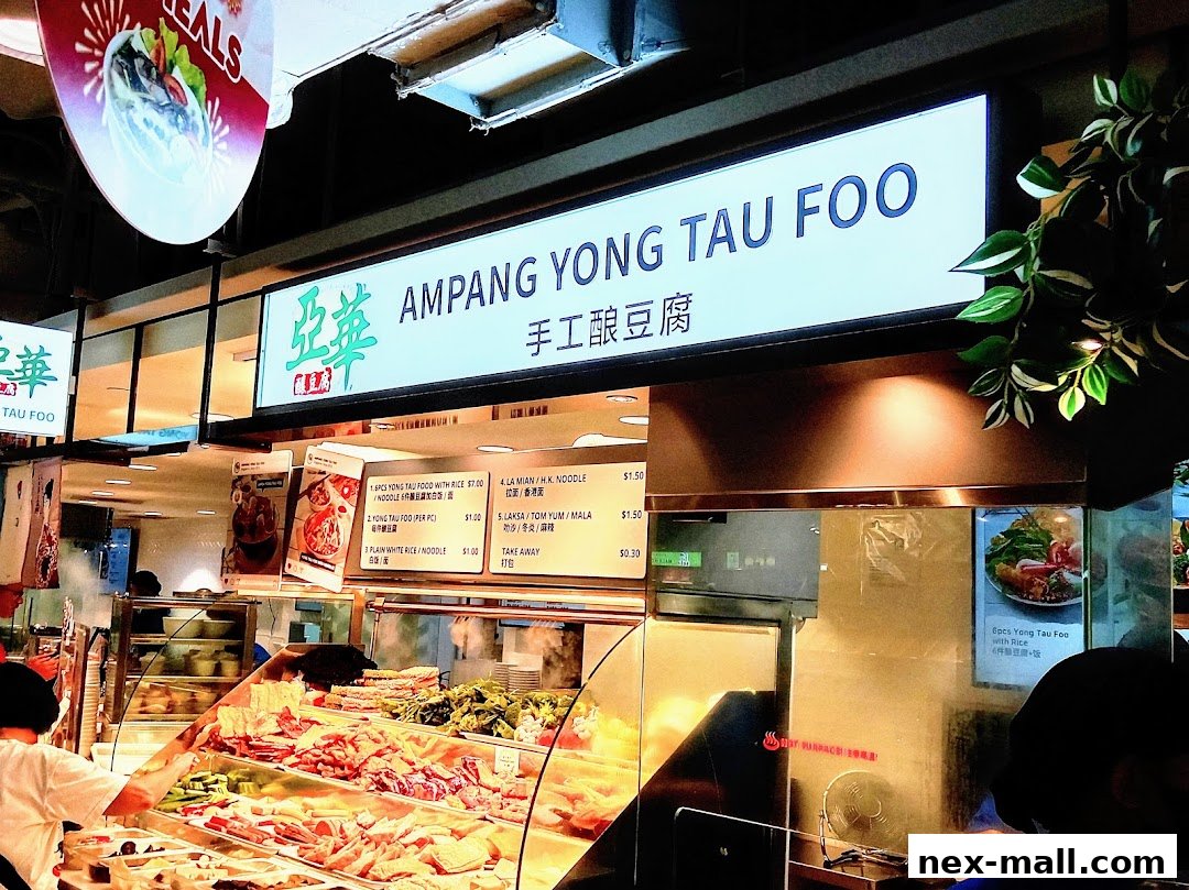 A food stall named Ampang Yong Tau Foo with a display of fresh ingredients and a menu.