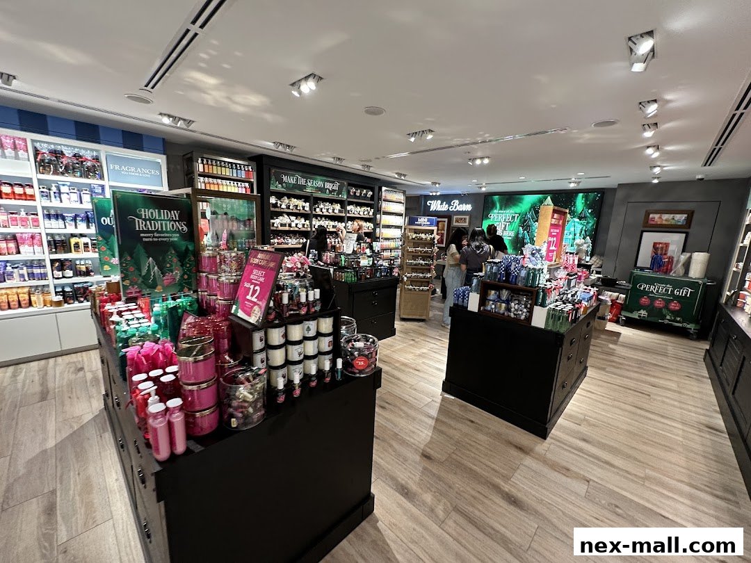 Interior view of Bath & Body Works store showcasing fragrances, candles, and holiday promotions.