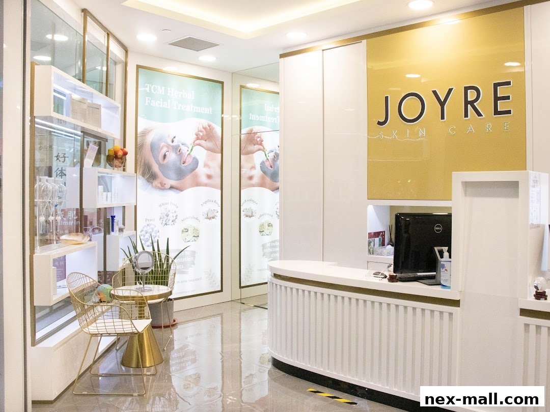 Interior of Joyre Skin Care, featuring a reception desk, product shelves, and promotional posters.