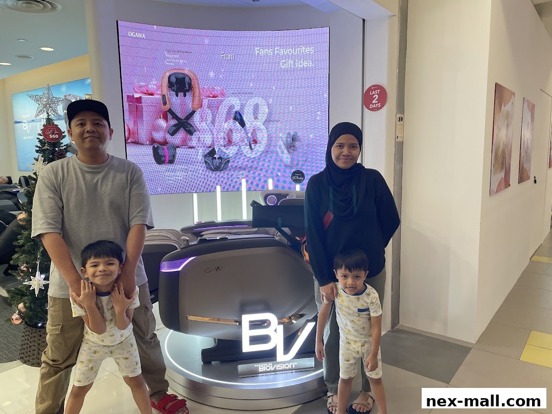 A family poses in front of a massage chair display at OGAWA NEX.
