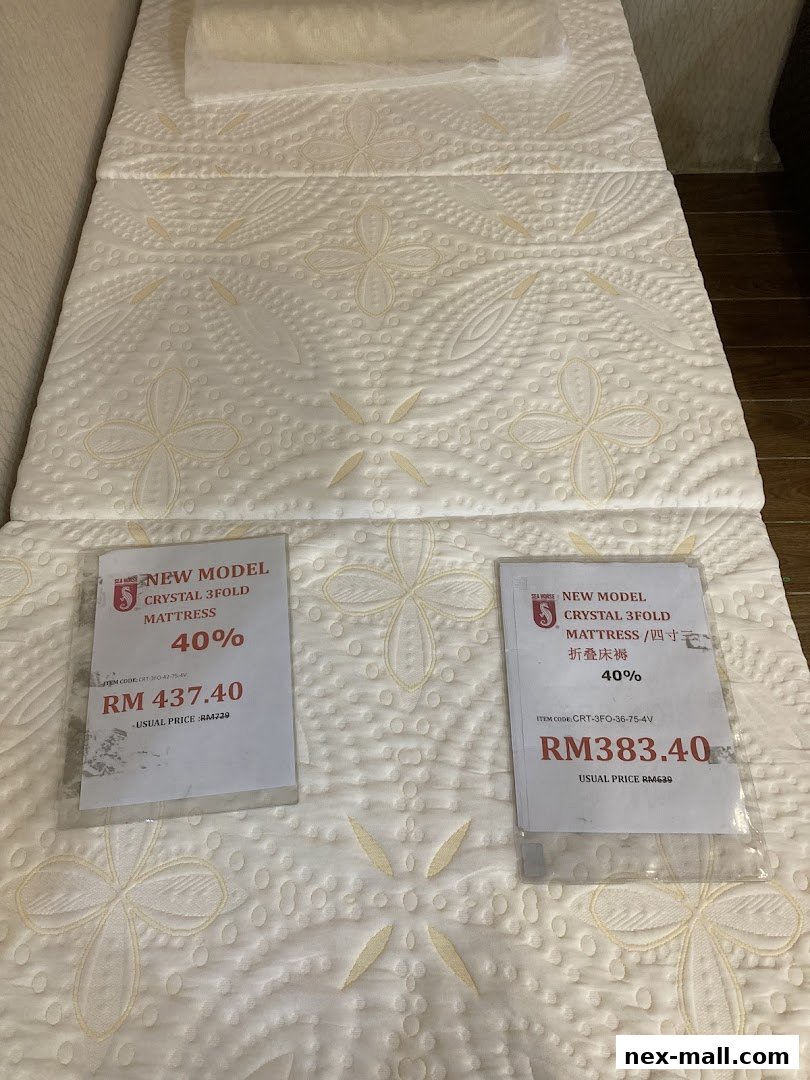 Two price tags displayed on a folded mattress with floral patterns.