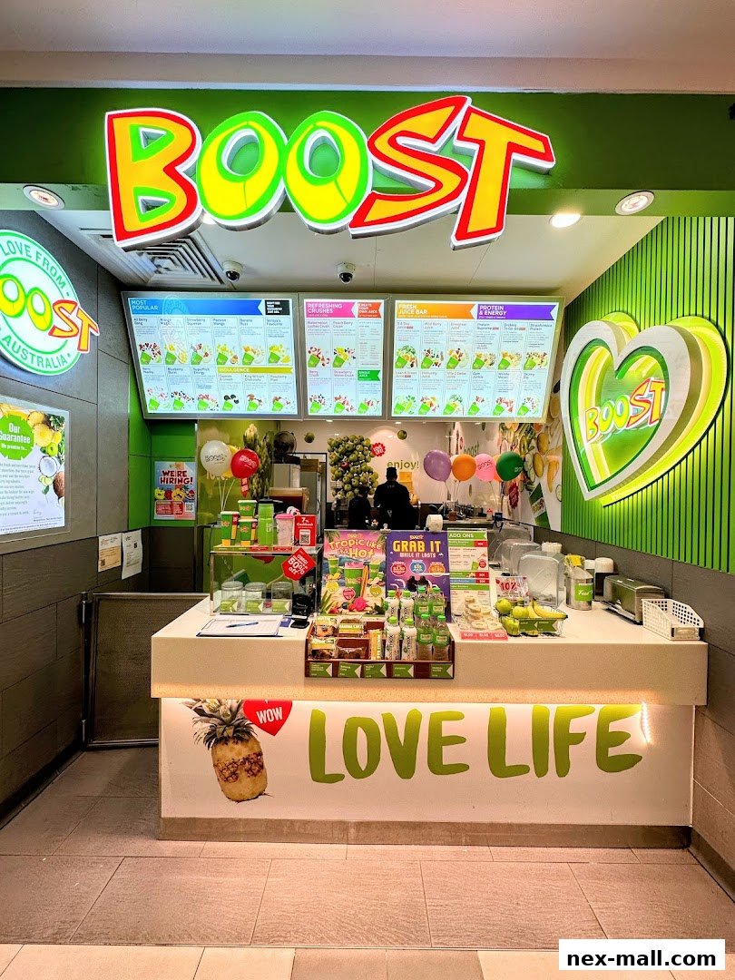 A Boost Juice shop with bright signage, menus, and a counter displaying products.