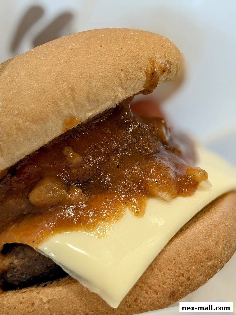 A close-up shot of a delicious MOS Burger with cheese and savory sauce.