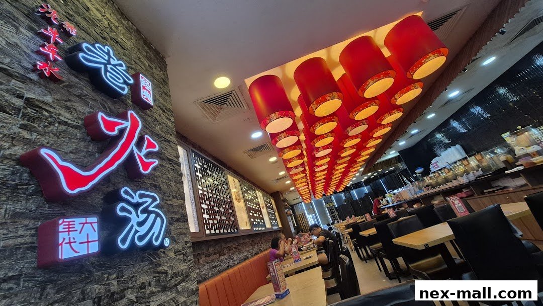 Interior of a restaurant with neon signs, red lanterns, and dining tables.