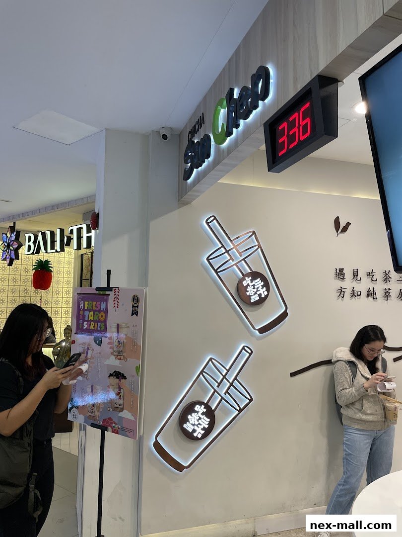 Customers at CHICHA San Chen NEX, with the shop's logo and a queue number display visible.