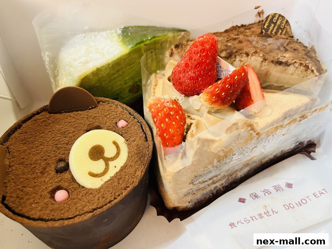 A box of assorted Châteraisé cakes, including a bear-shaped chocolate cake and strawberry cake.