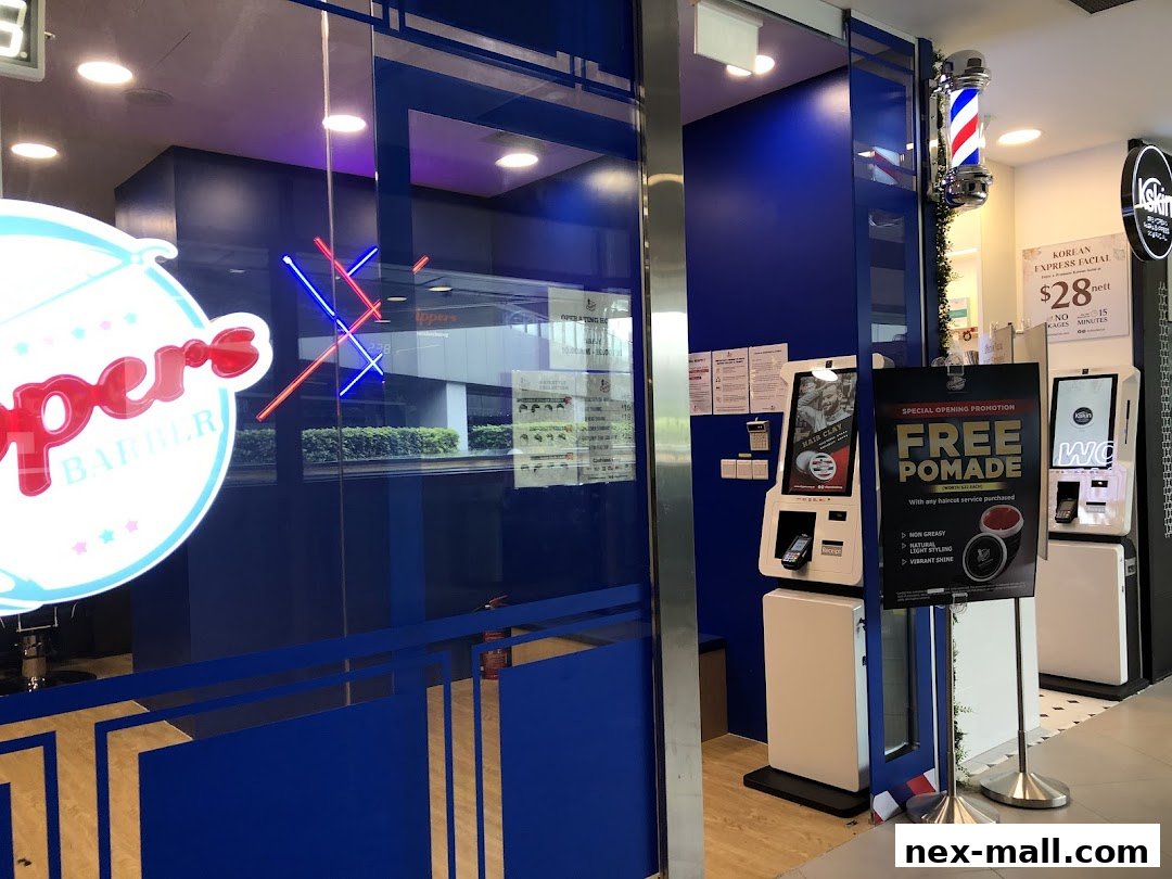 The entrance of Clippers Barber shop with a neon sign and promotional posters.