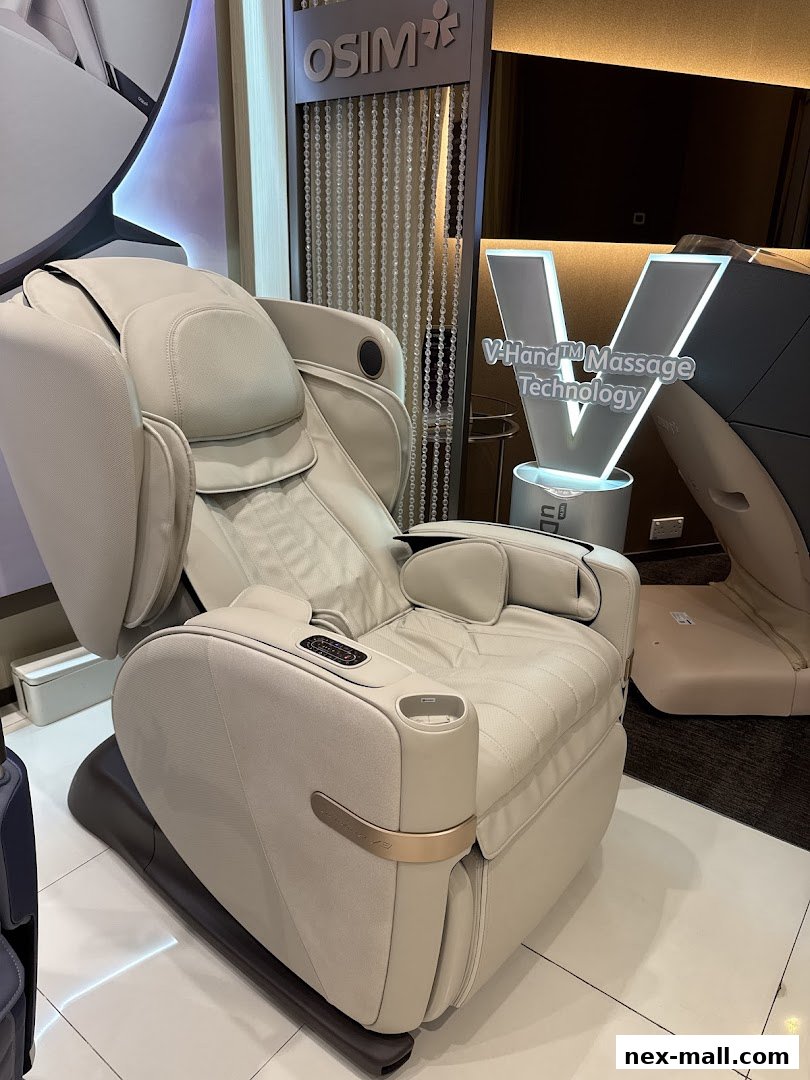 A luxurious beige massage chair with the OSIM logo and V-Hand Massage Technology.
