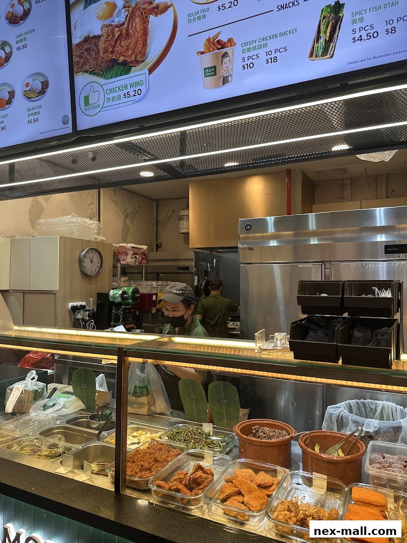 A food stall counter displaying various nasi lemak ingredients and menu items.