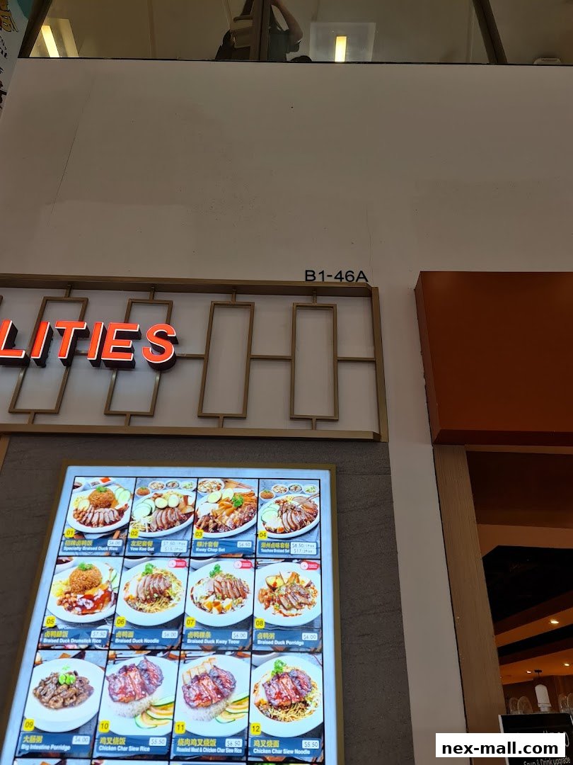 A digital menu board displaying various duck and meat dishes with prices.