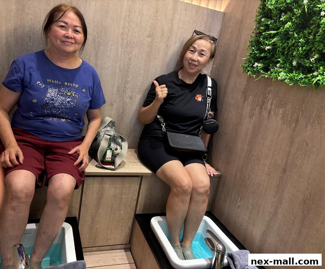 Two women enjoying foot reflexology treatments in a relaxing spa environment.