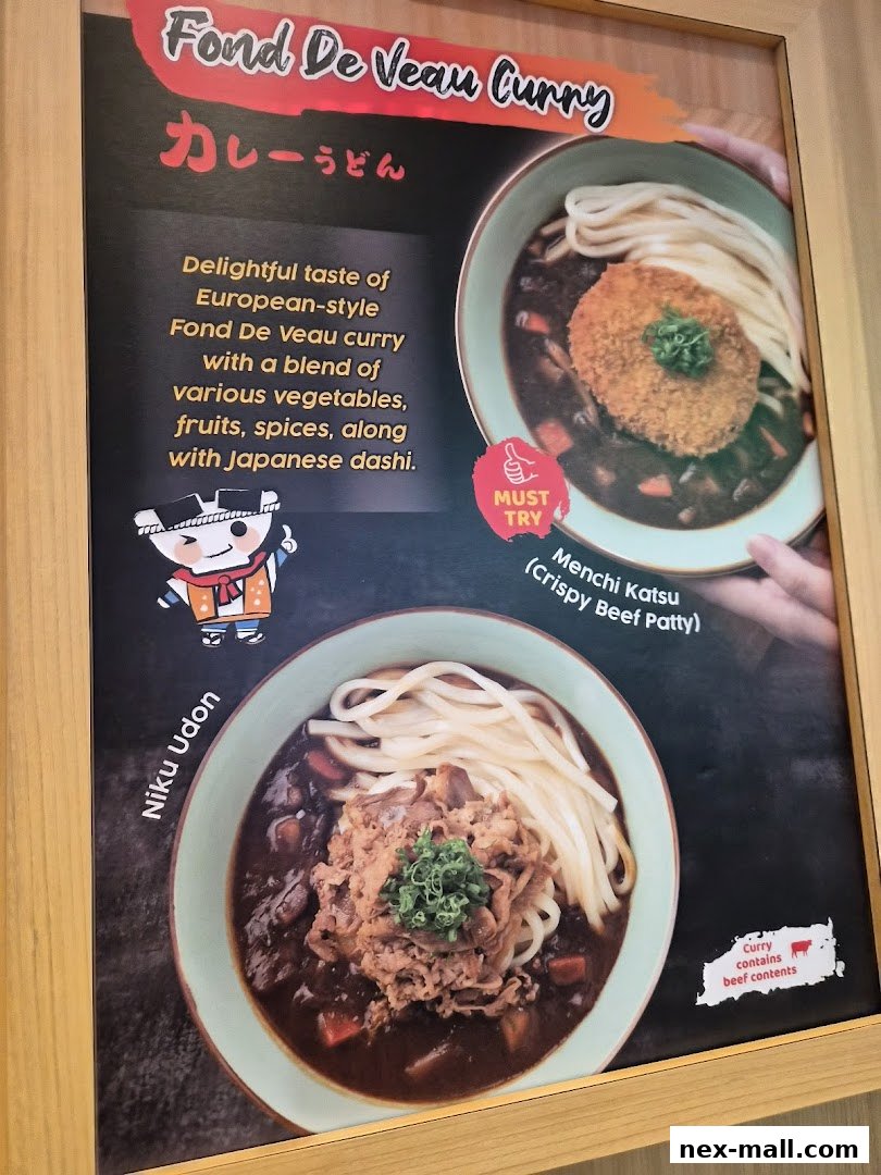 A menu board showcasing Fond De Veau Curry Udon with Niku Udon and Menchi Katsu.