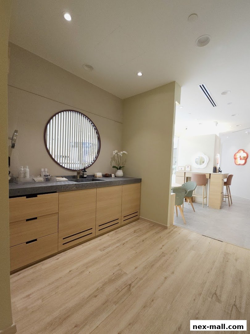 Interior view of a modern beauty or wellness shop with a vanity area and seating.