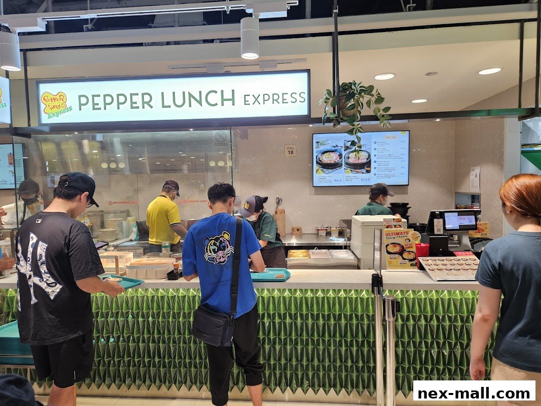 Customers queue at Pepper Lunch Express, a food stall with a digital menu and counter service.