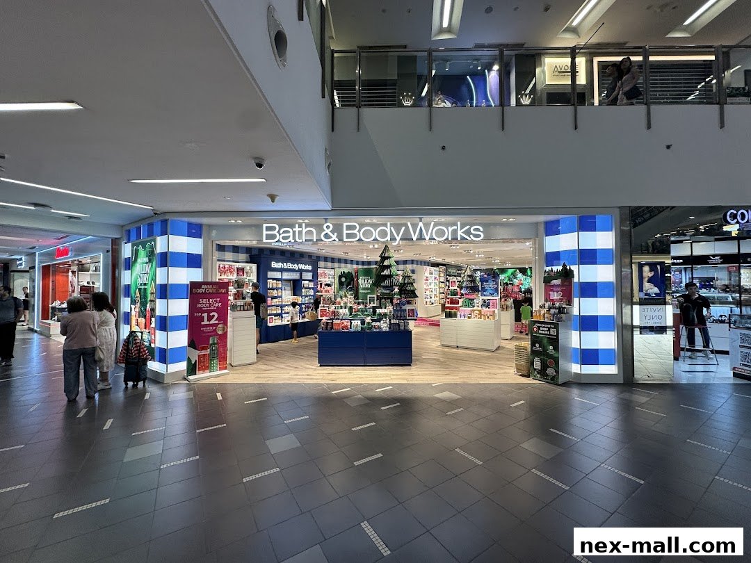 The brightly lit Bath & Body Works store entrance with displays of products and holiday decorations.