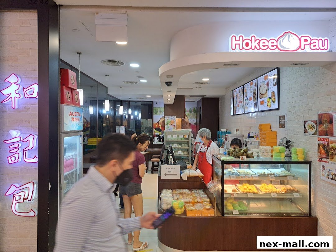 Ho Kee Pau shop interior with display cases of food and staff serving customers.