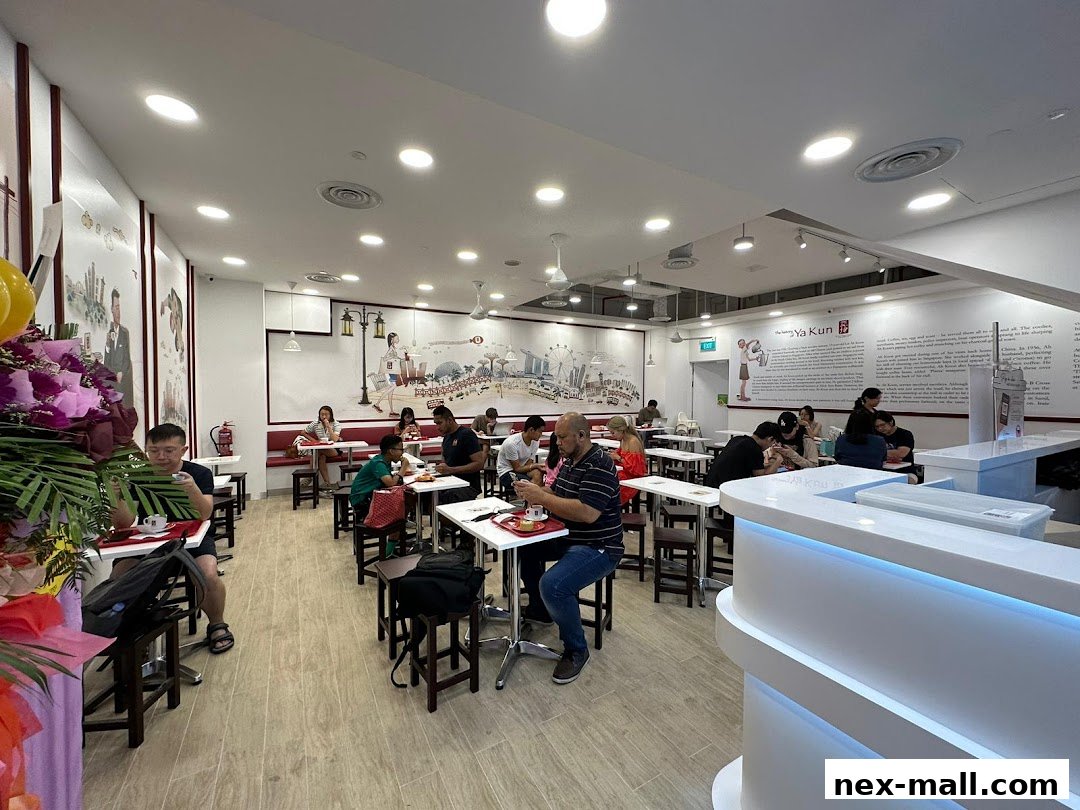 Interior view of Ya Kun Kaya Toast with customers dining and a counter area.