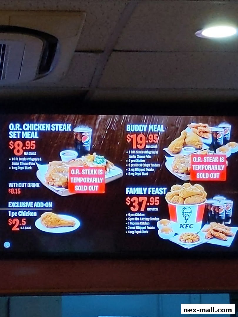 A digital menu board displaying various KFC meal deals and prices.