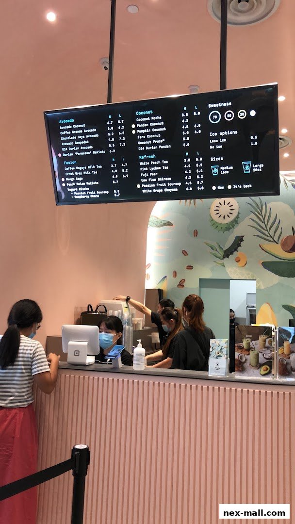 A digital menu board displaying various drinks and their prices at Fruce NEX.