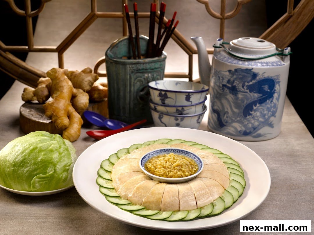 A plate of sliced chicken with cucumber and ginger paste, served with a head of lettuce and a teapot.