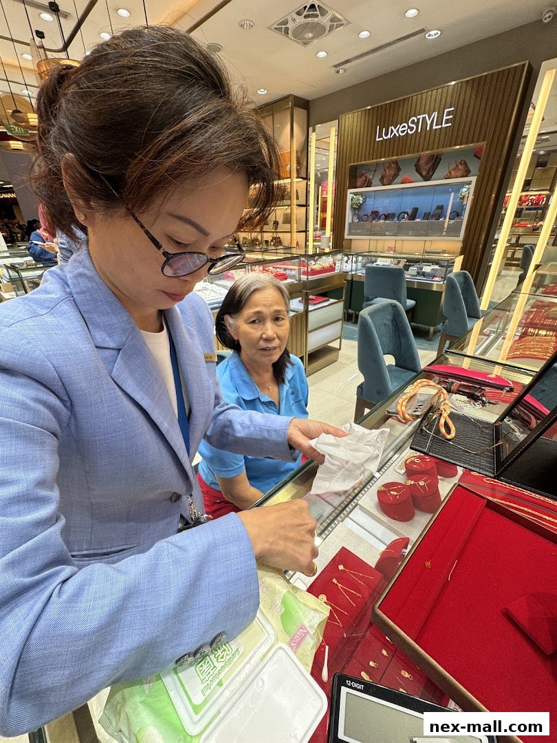 Two women are looking at jewelry displayed in a store with a Luxe STYLE sign.