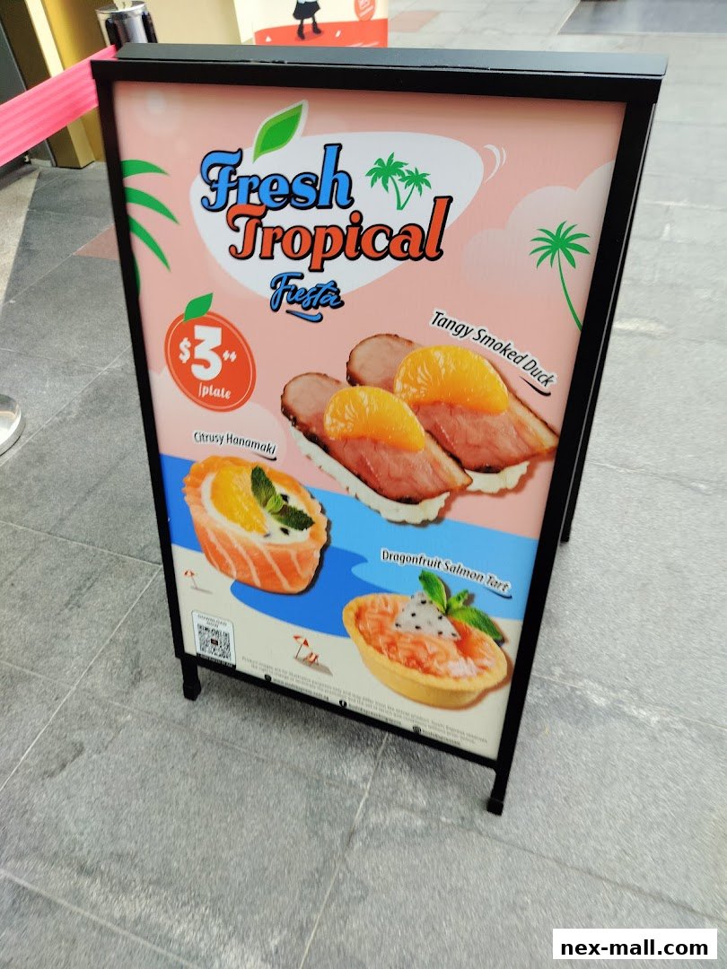 A-frame sign advertising Sushi Express's Fresh Tropical Fiesta with various sushi dishes.