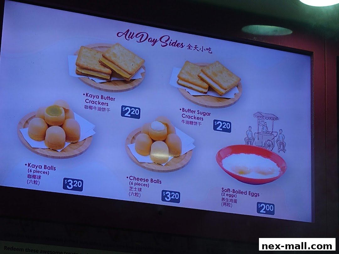 A menu board displaying various snacks like kaya balls, crackers, and soft-boiled eggs.