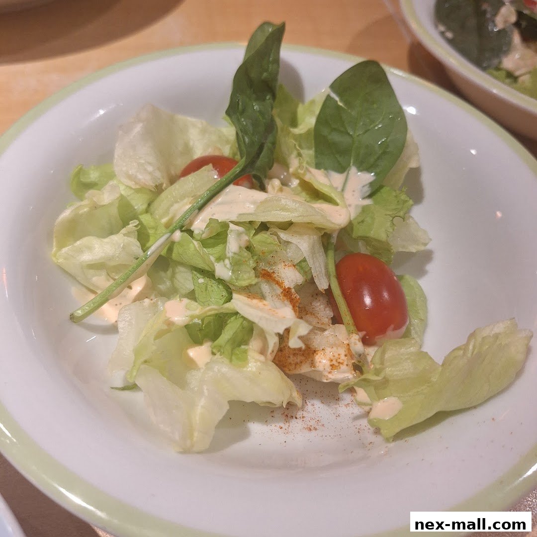 A close-up shot of a fresh salad with lettuce, cherry tomatoes, and dressing.