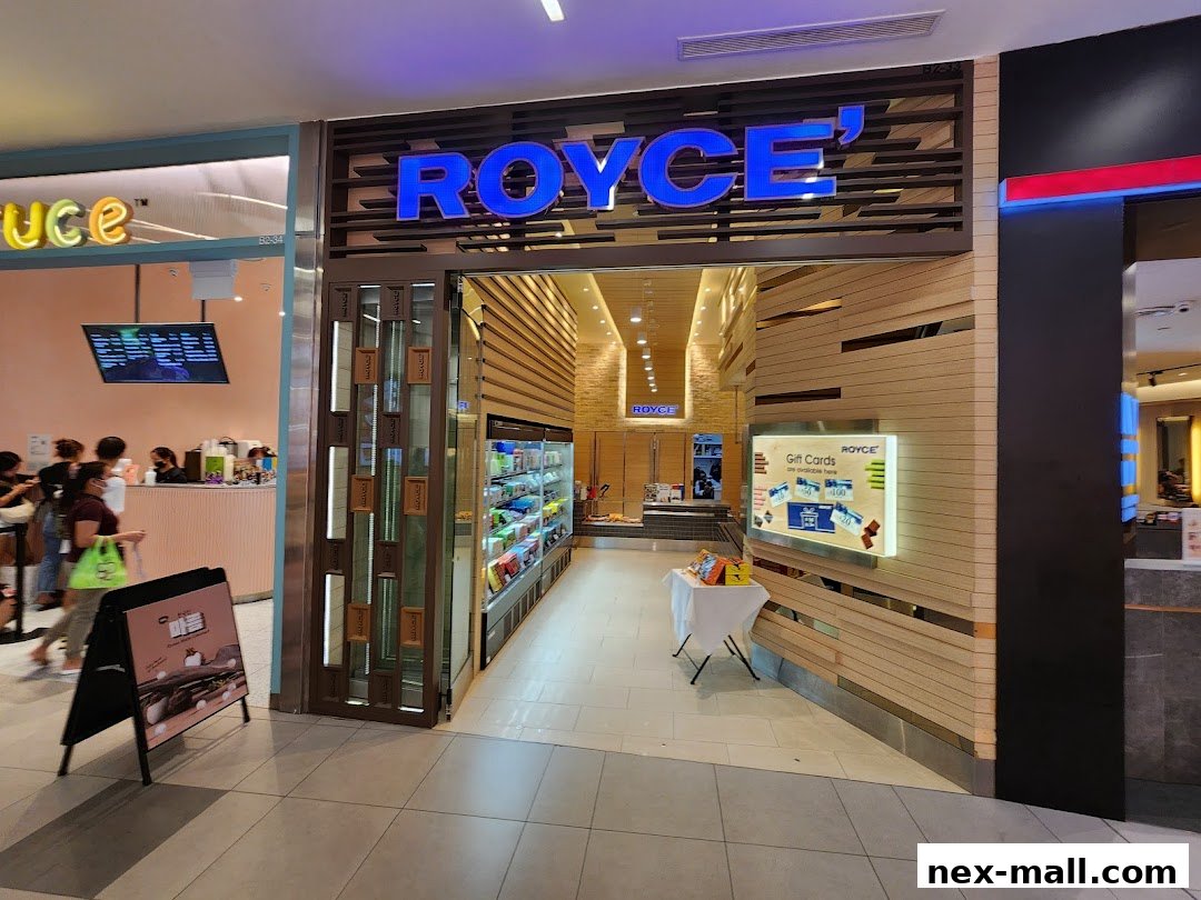 The Royce shop front with bright blue signage and a display of products inside.
