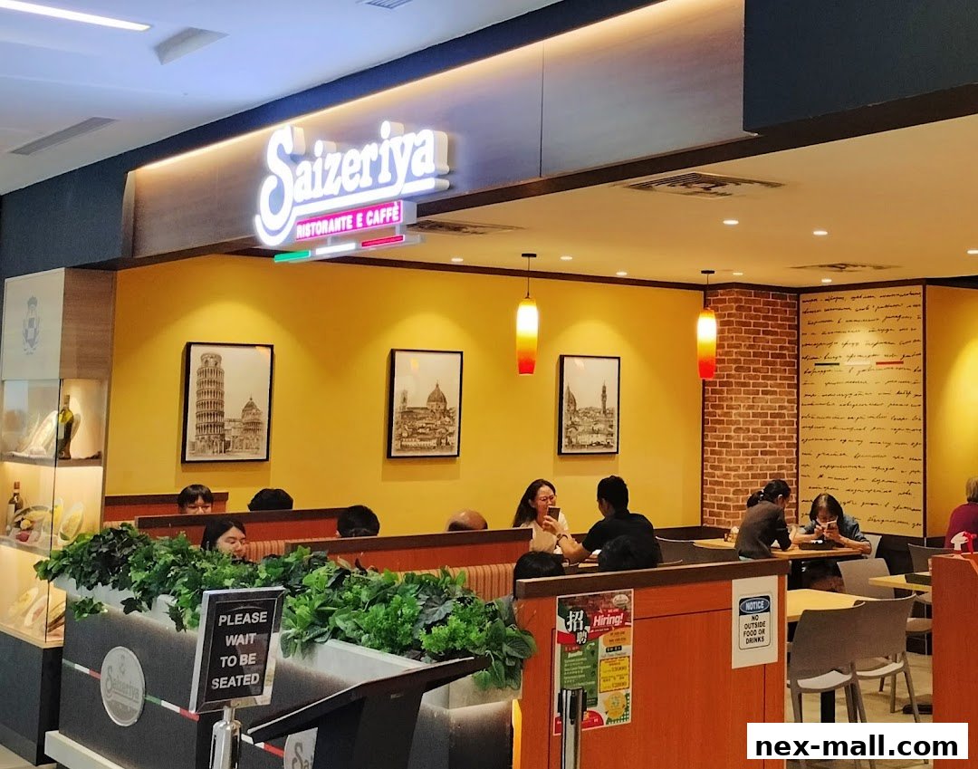 Interior of Saizeriya restaurant with customers seated at tables and a prominent "Saizeriya Ristorante E Caffè" sign.