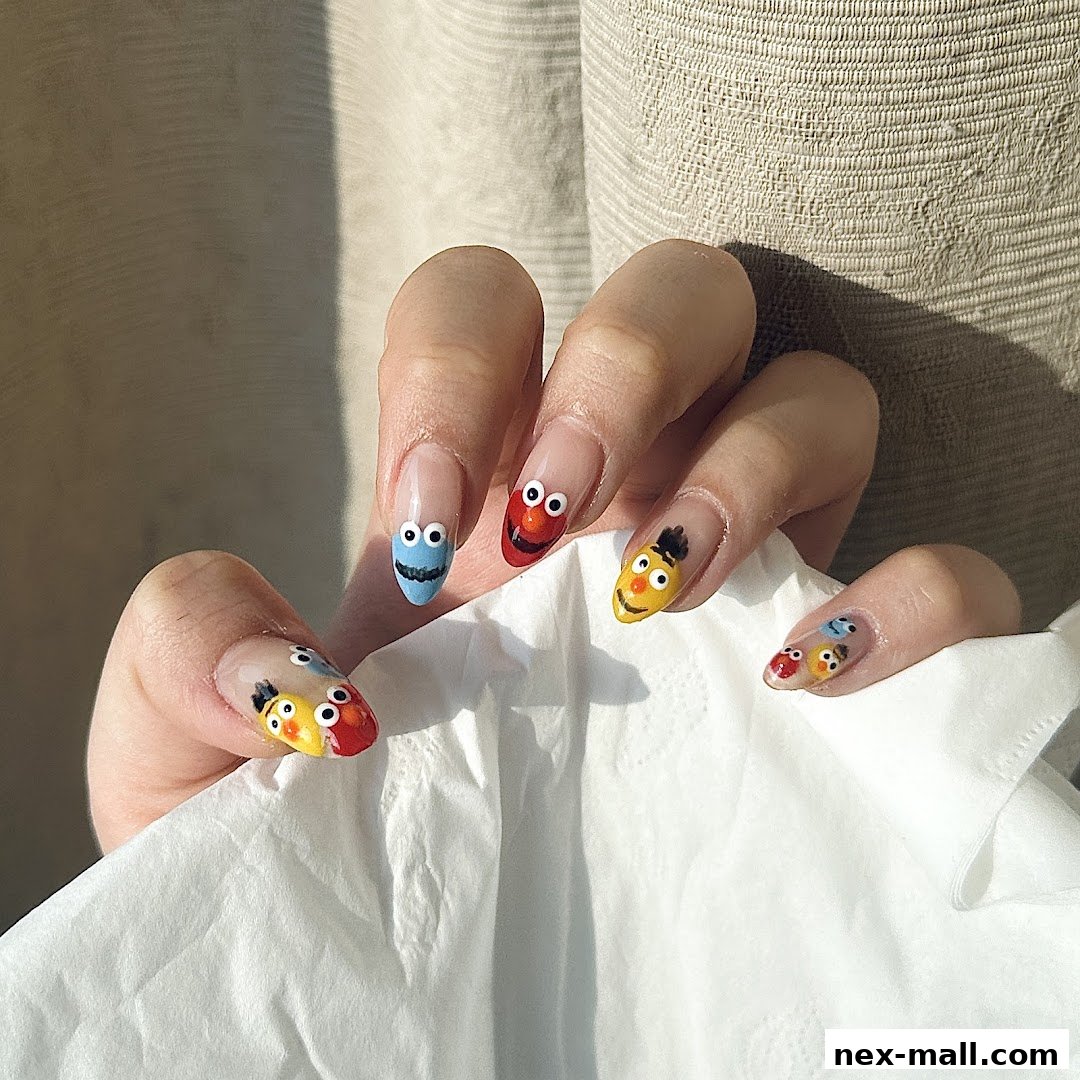A close-up of hands with intricately designed nails featuring Sesame Street characters.