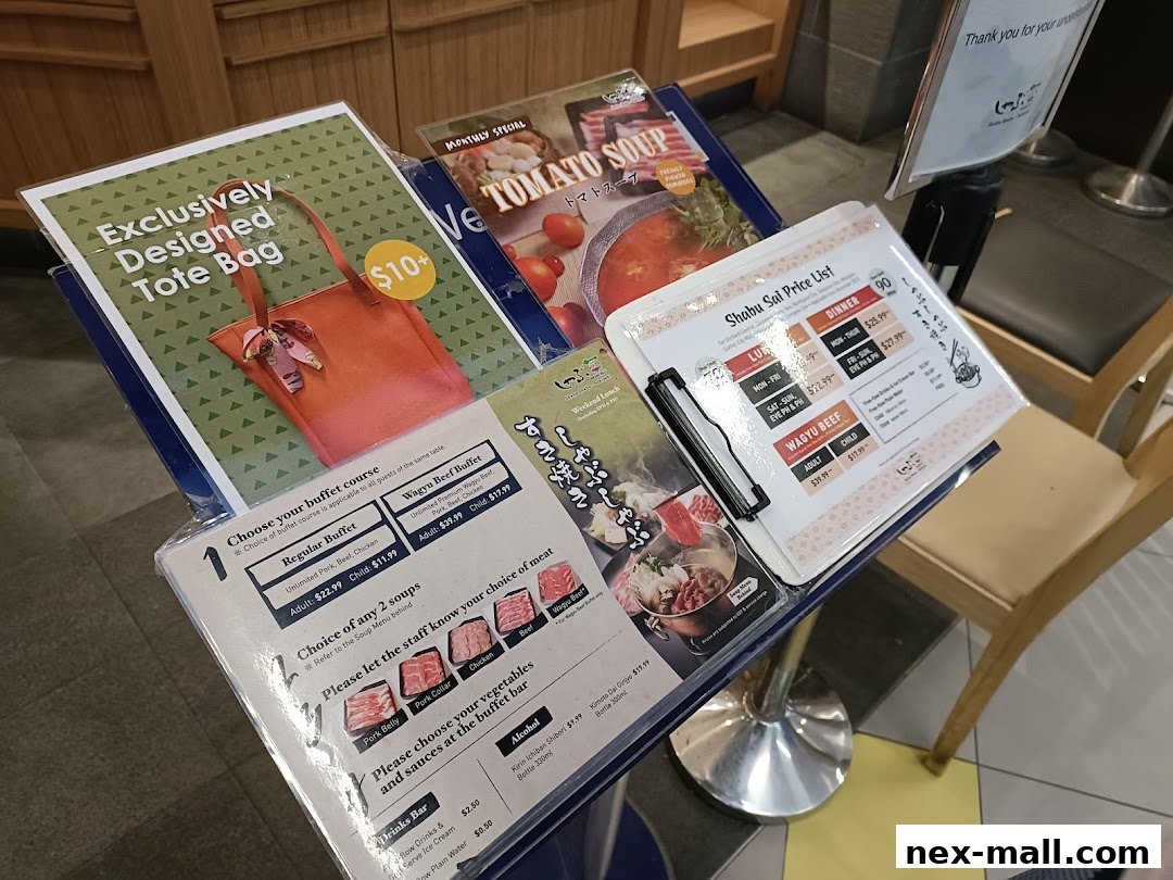 A display of menus and price lists for Shabu Sai, featuring buffet options and specials.
