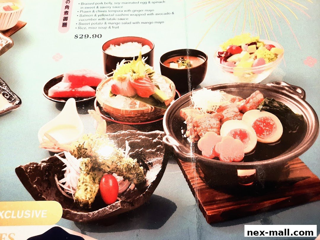 A Japanese meal set featuring various dishes including sashimi, tempura, and braised pork belly.