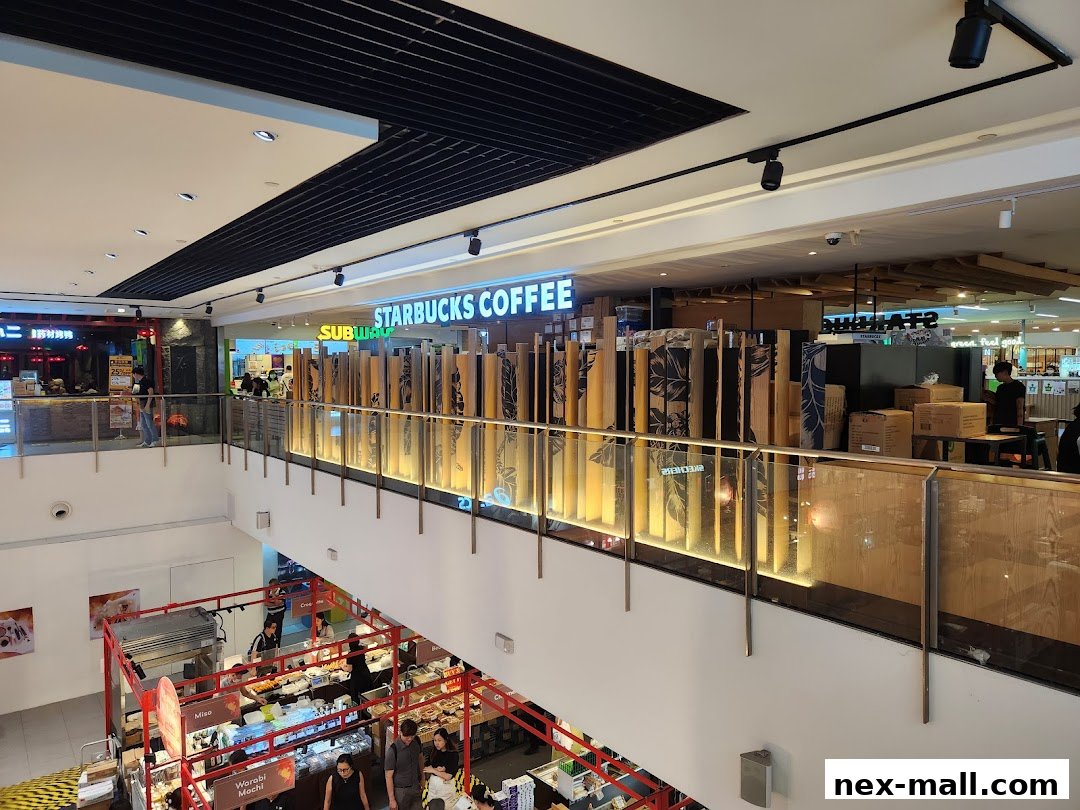 View of Starbucks and Subway stores on the upper level of a shopping mall.