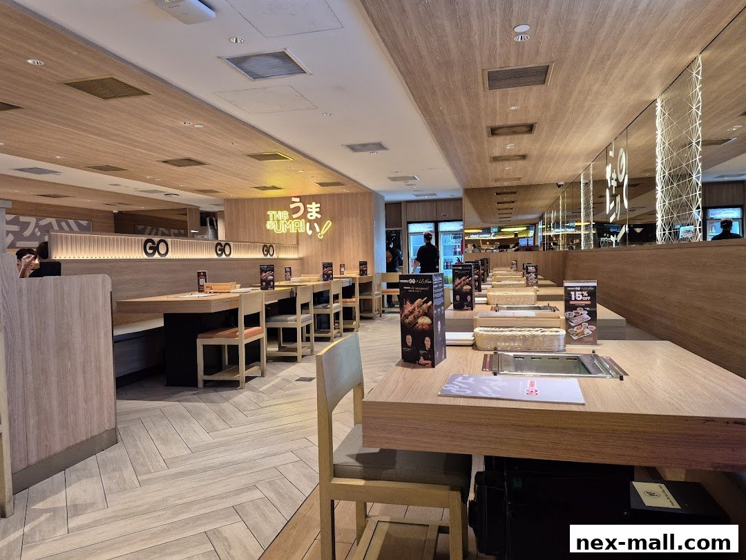 Interior view of a Yakiniku-GO NEX restaurant with tables set for dining.