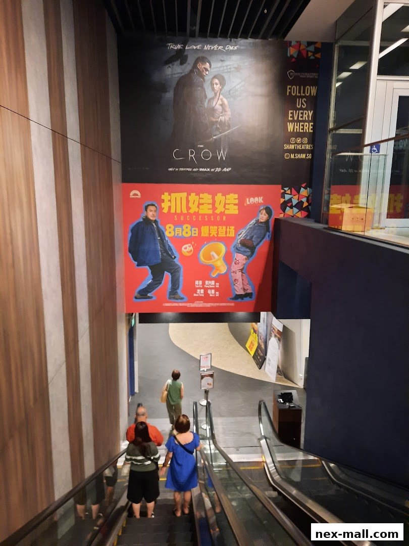 People on escalators at Shaw Theatres NEX, with movie posters displayed above.