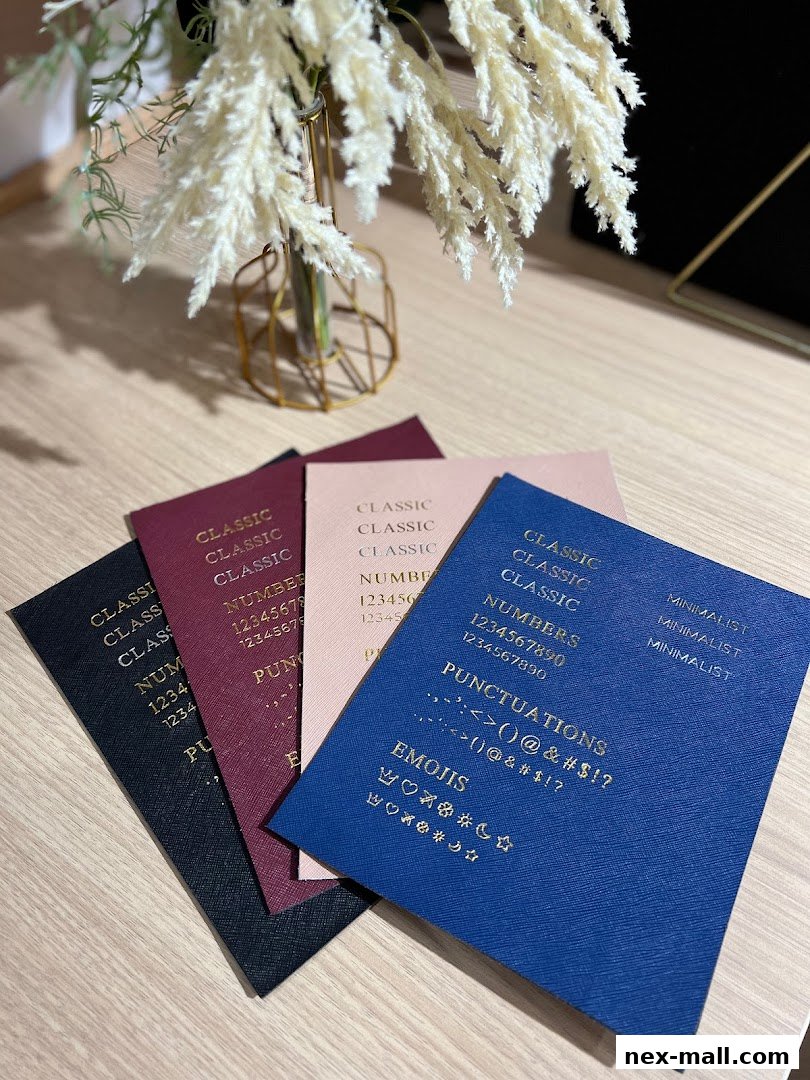Four colorful notebooks with embossed text and symbols are displayed on a wooden surface.