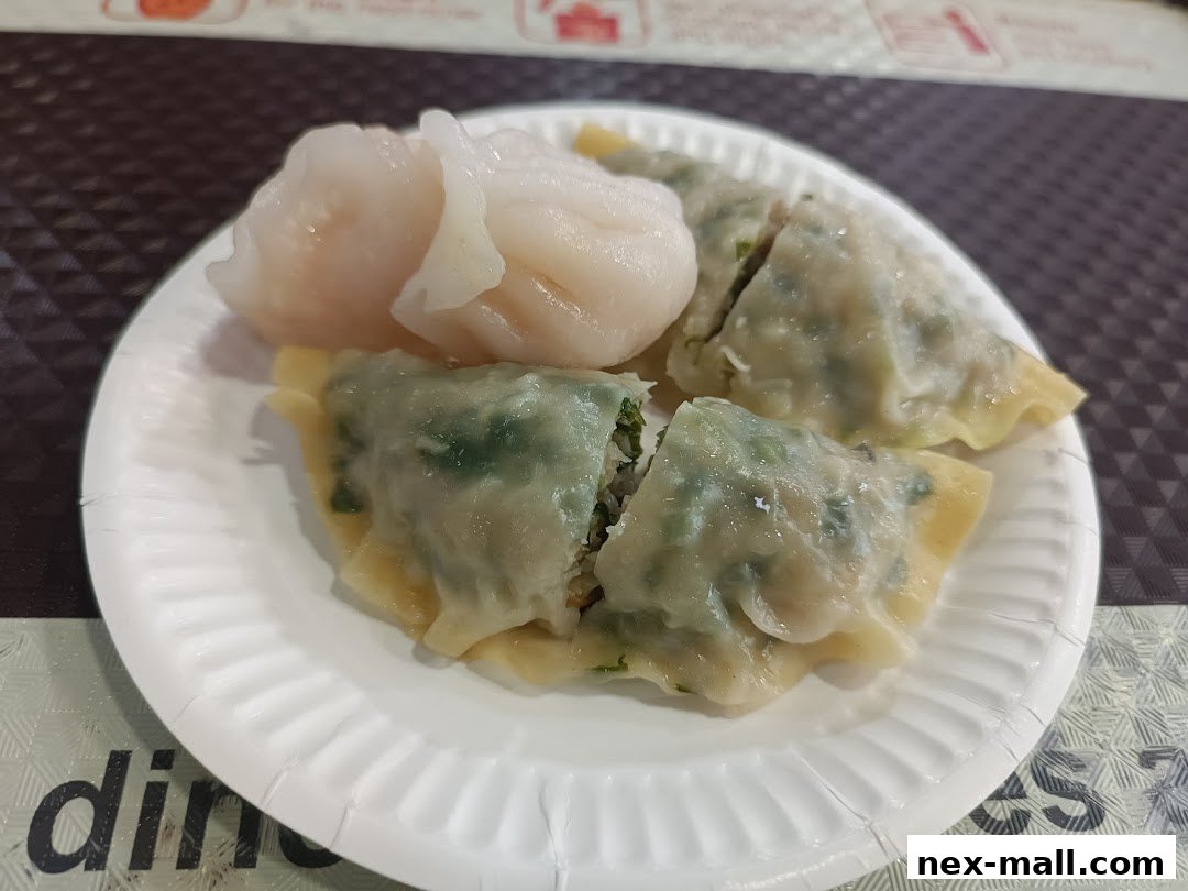 A plate of delicious dim sum, featuring har gow and pan-fried dumplings.