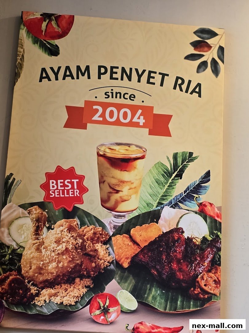 Ayam Penyet Ria sign featuring popular dishes and the establishment date.