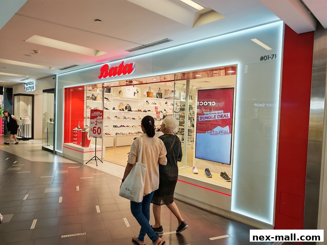 The Bata shoe store entrance with shoes displayed inside and a promotional sign.