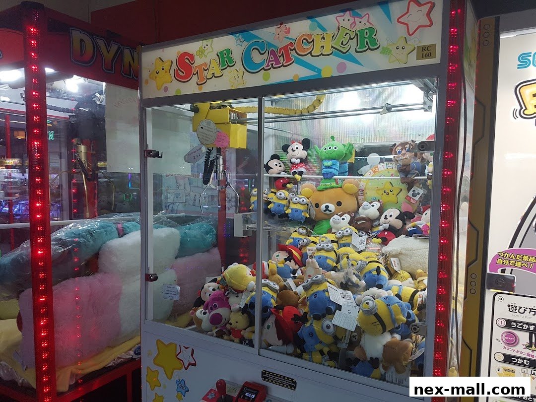 A claw machine filled with various plush toys, including Minions and Disney characters.