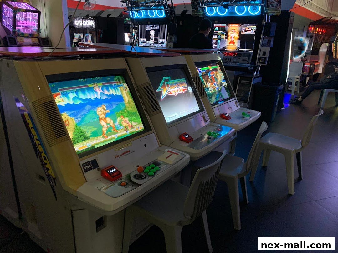 Row of vintage arcade game cabinets with fighting game displays and chairs.
