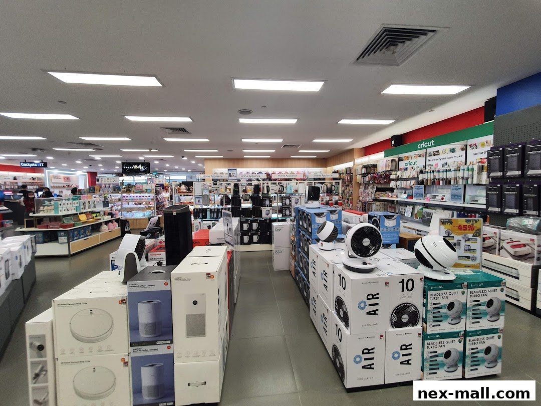 Interior view of a well-lit electronics and home appliance store with various products on display.