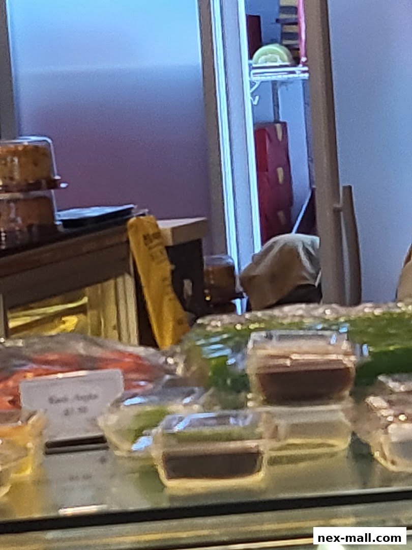 A display case filled with various food items, including cakes and small desserts.