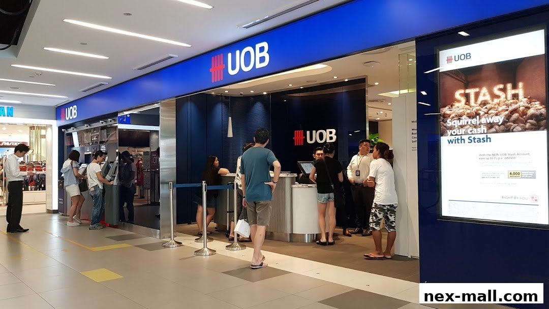 The UOB Serangoon Central Branch entrance with customers using ATMs and at the counter.