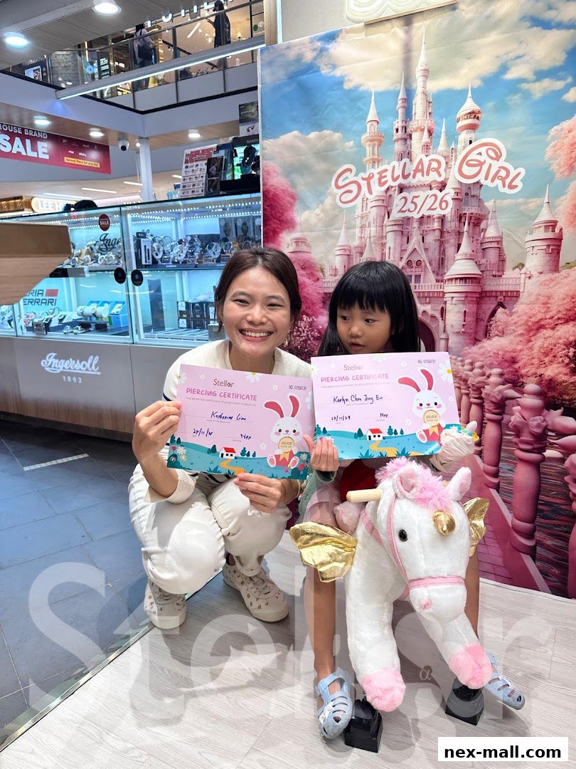 A woman and a child hold piercing certificates with a unicorn toy and a castle backdrop.