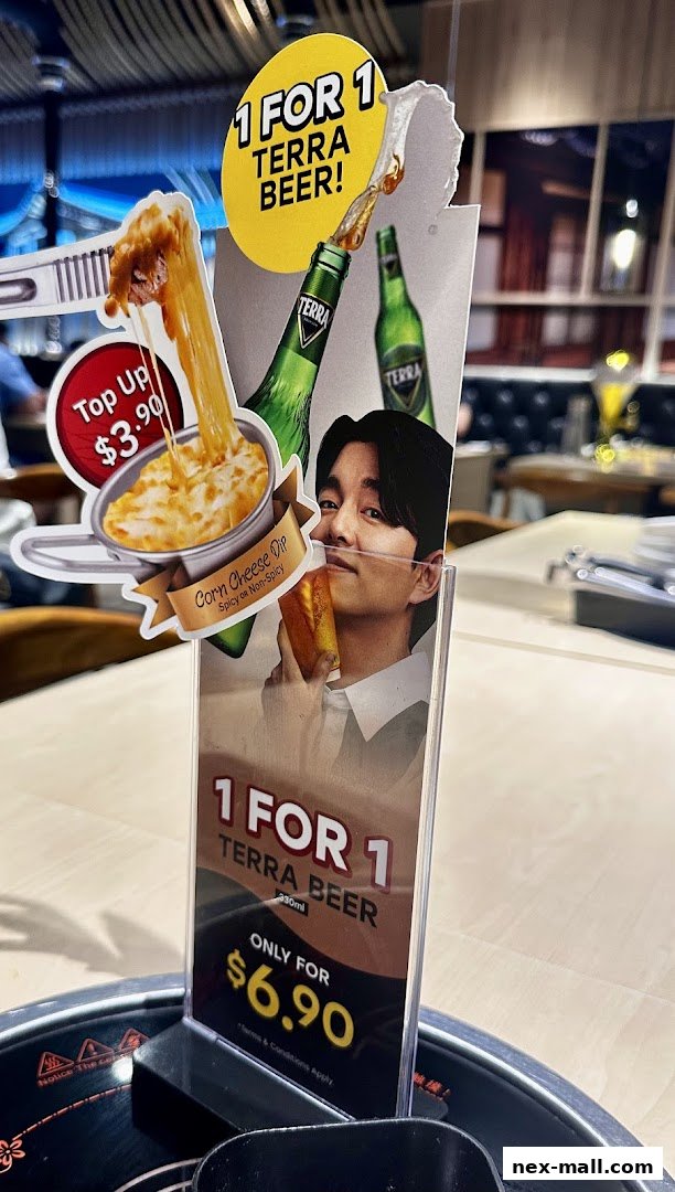 A promotional display for a 1-for-1 Terra Beer offer and a corn cheese dip.