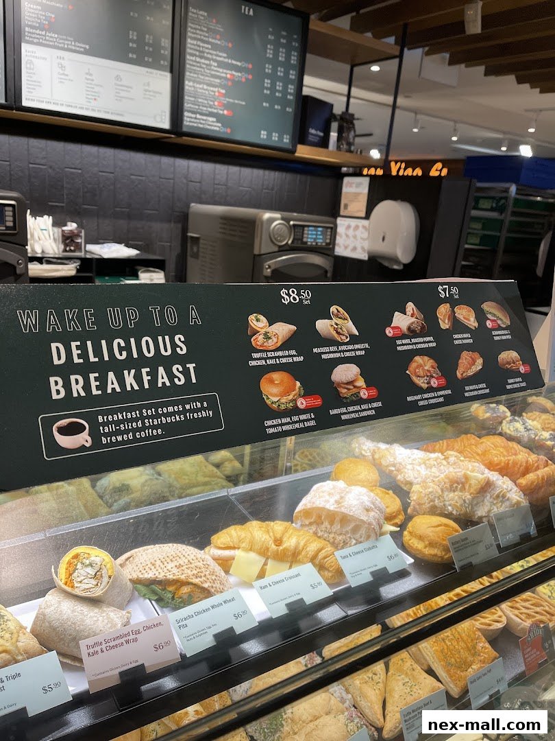 A display case filled with various breakfast items and a menu board above.